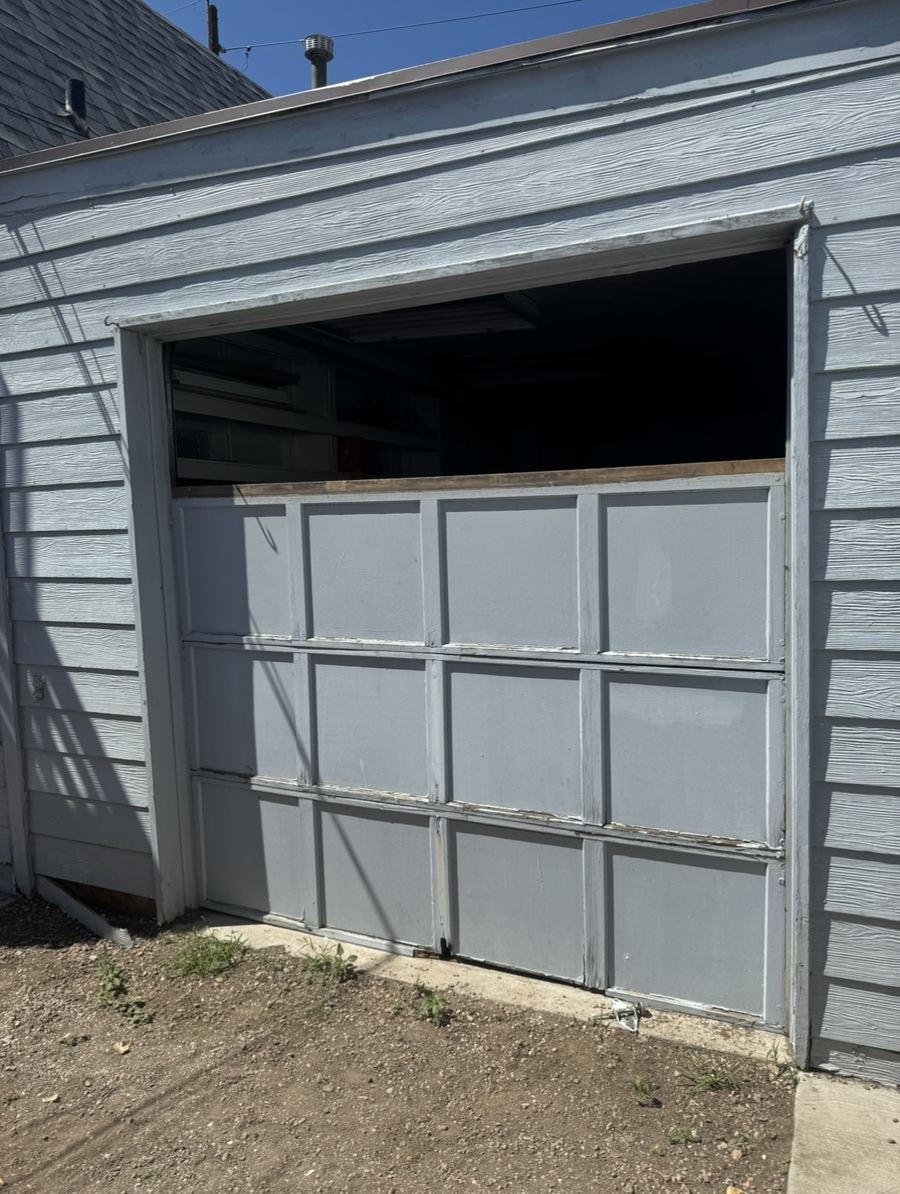 Garage door mid-repair with the top panels removed