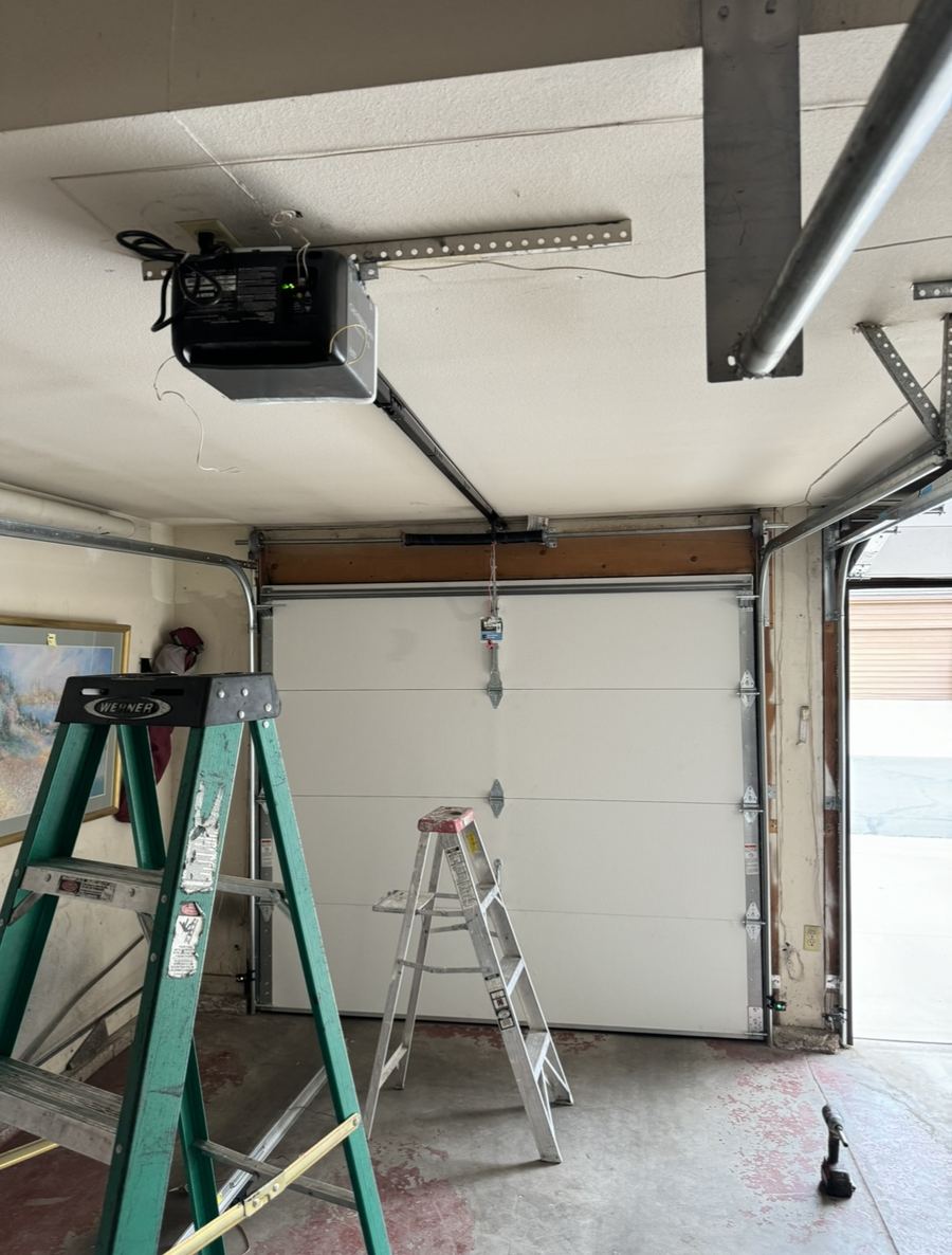 Torsion spring and opener rail above a garage door in an Encino home